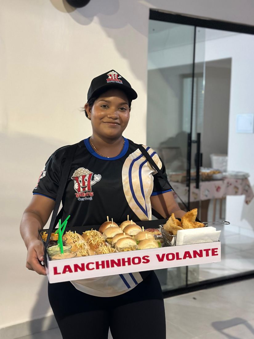 Monitora levando a bandeja de lanchinhos até os convidados